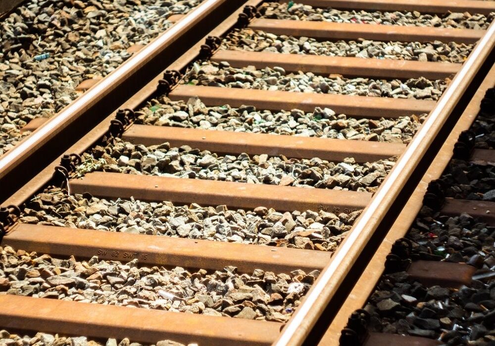 A close-up, diagonal view of railroad tracks and ballast.